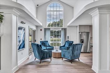 A living room with two blue chairs